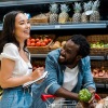 a couple laughing together at a grocery store