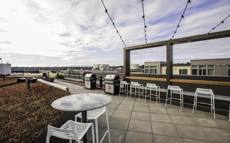 a rooftop patio with tables and chairs